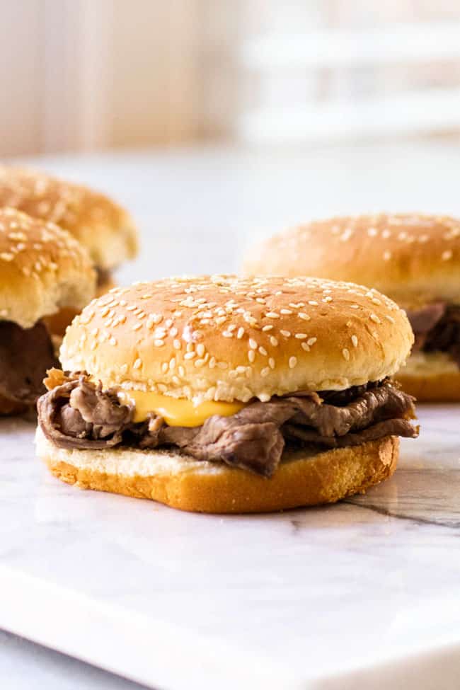 Hot roast beef on a sesame hamburger bun with cheddar cheese sauce