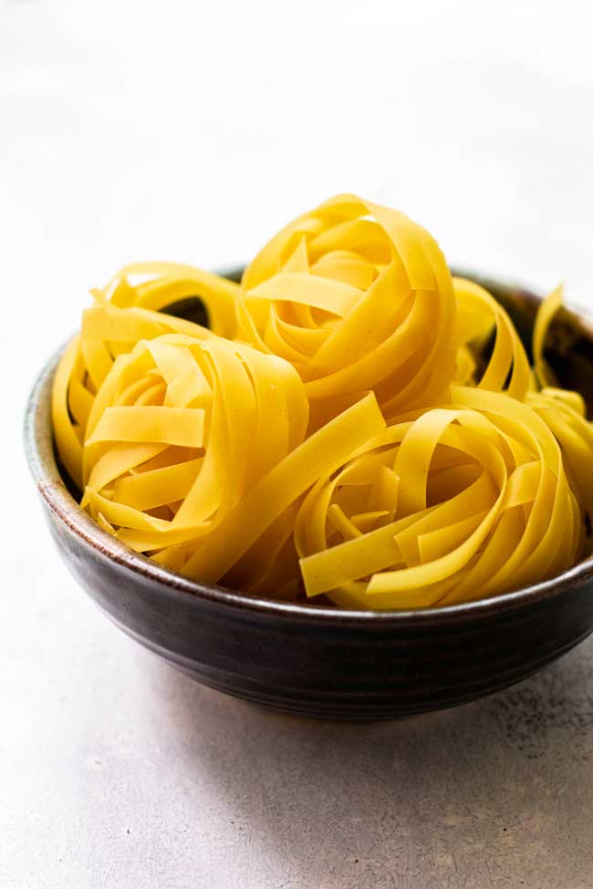 A bowl with nests of uncooked pappardelle pasta
