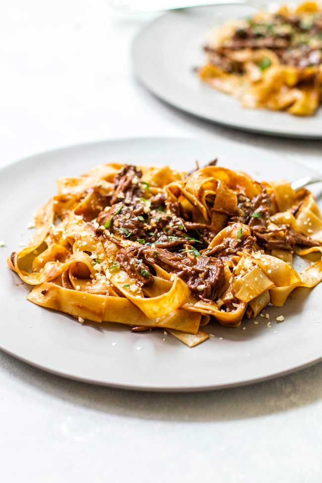 A plate of braised short rib mushroom sauce with pasta