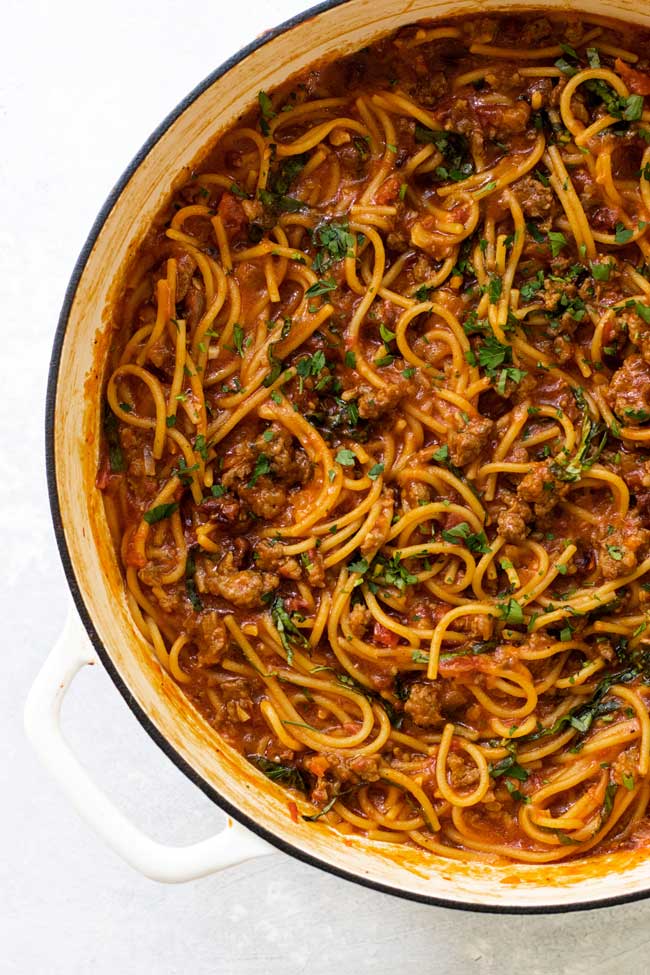 Spaghetti bolognese in a large white pan