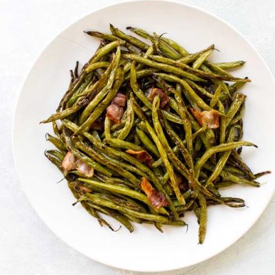 Roasted green beans on a white plate