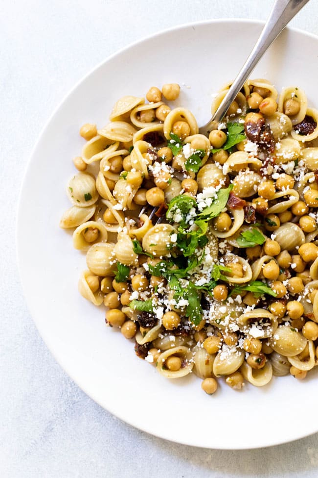 orecchiette with chickpeas and feta on a white plate