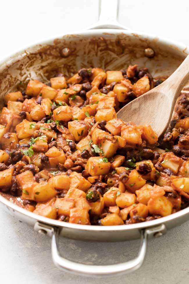 Step one is to make the black bean and potato filling in a skillet