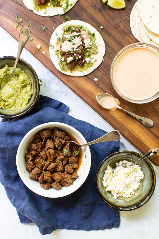 All of the components for braised beef tacos on a tabletop 