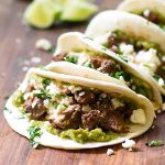braised beef tacos on a cutting board