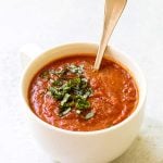 one serving of tomato basil soup in a white bowl