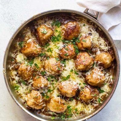 overhead photo of a skillet of french onion chicken meatballs