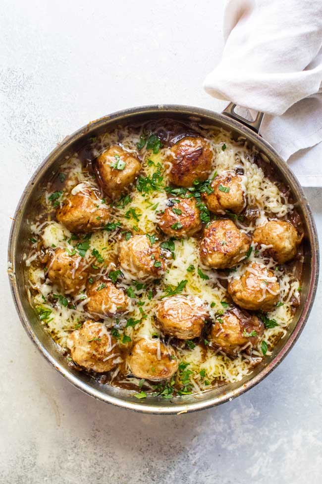 overhead photo of a skillet of french onion chicken meatballs