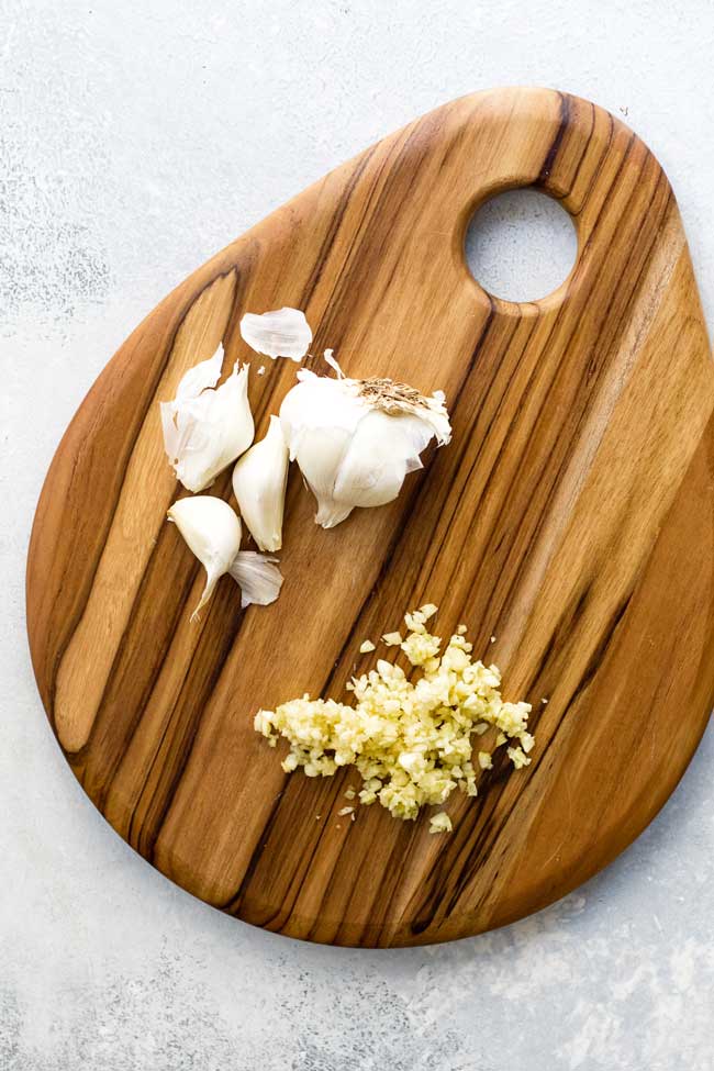 photo of chopped garlic on a cutting board