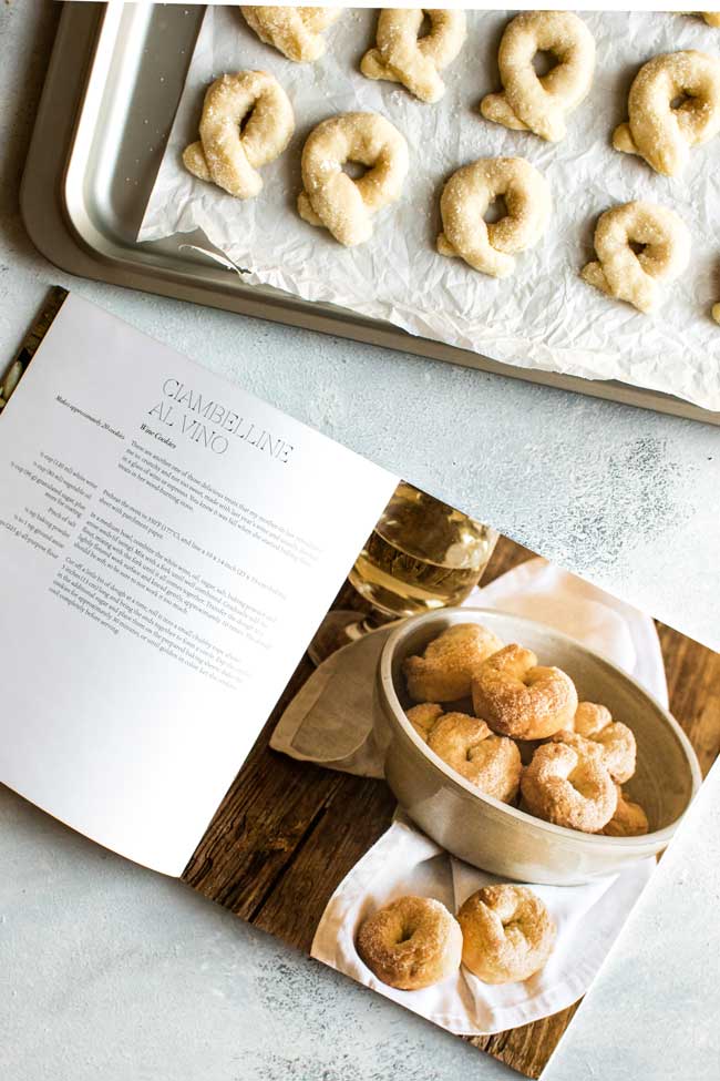 overhead photo of a cookbook and baking sheet with cookies ready to bake