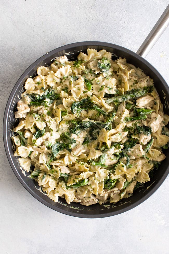overhead photo of a skillet of broccoli rabe chicken pasta