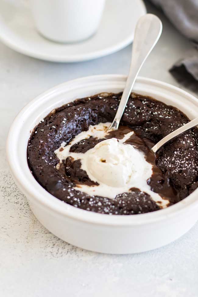 close-up photo of a mocha pudding cake topped with ice cream