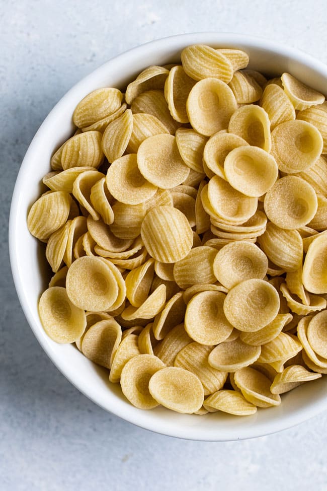 Overhead photo of a bowl of uncokked orecchiette pasta