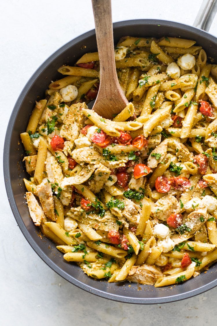 overhead photo of pesto chicken pasta in a skillet