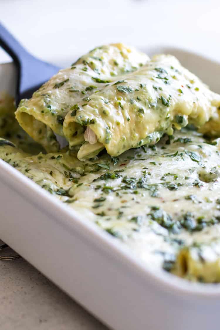 photo of two enchiladas being lifted out the pan