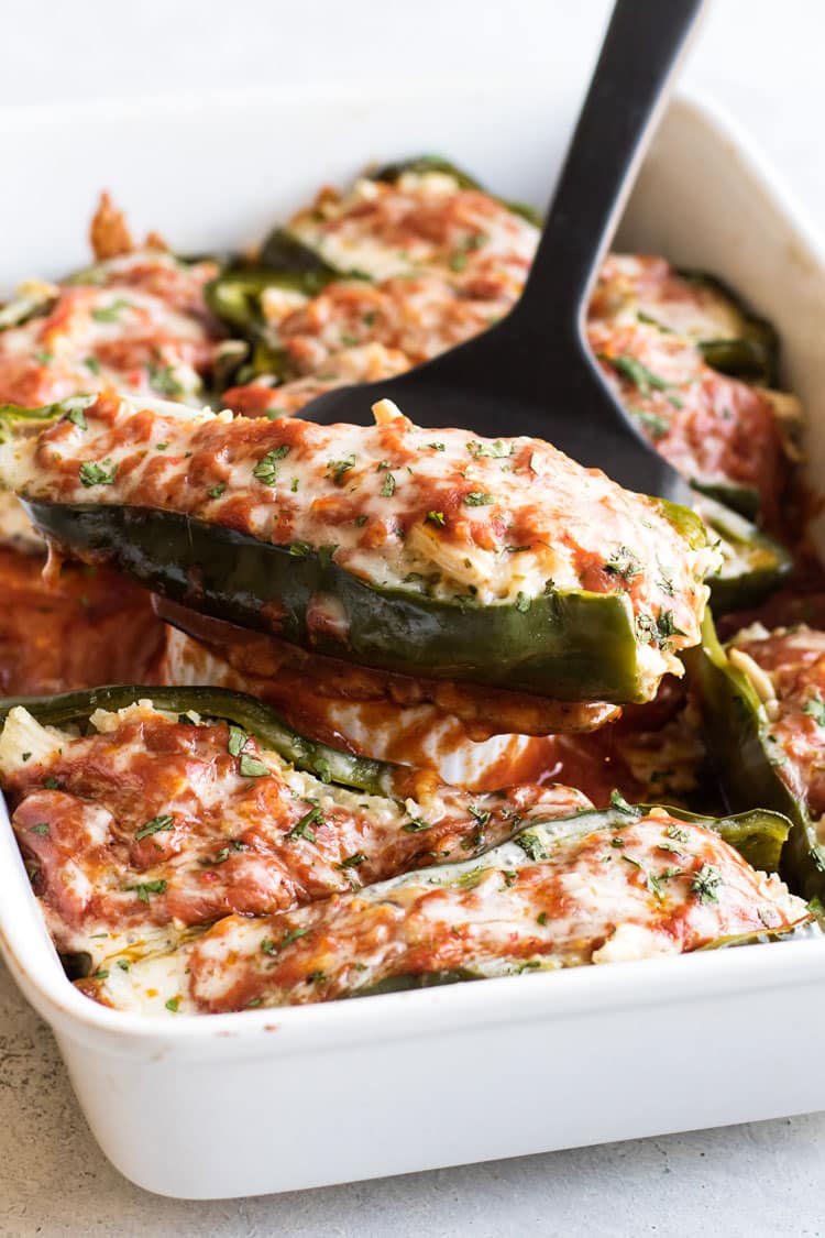 photo of a stuffed pepper being lifted out of a baking dish