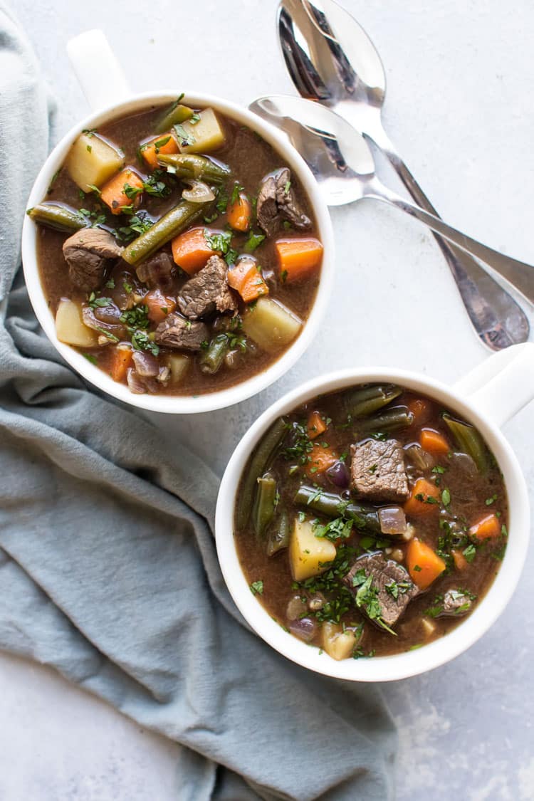 Overhead photo of two bowls of vegetable beef soup