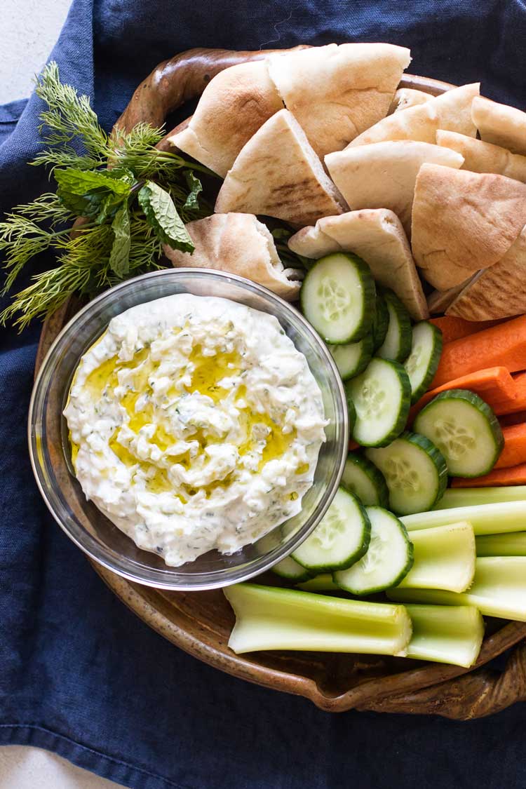 photo of a vegetable platter with bowl of tzatziki