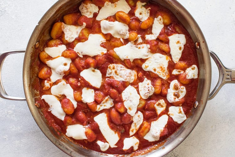 photo of gnocchi in tomato sauce with melted cheese on top