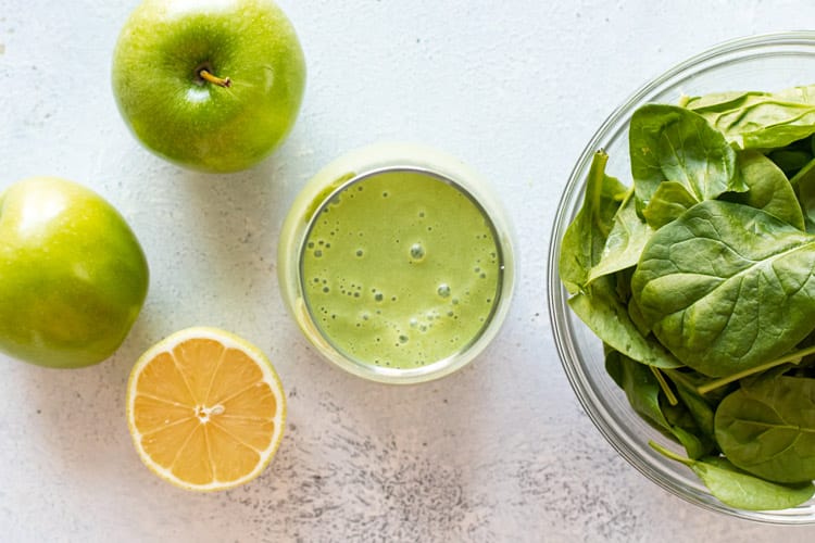 overhead photo of a smoothie with the ingredients to make it