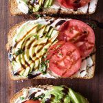 overhead photo of avocado toast with tomatoes and balsamic glaze
