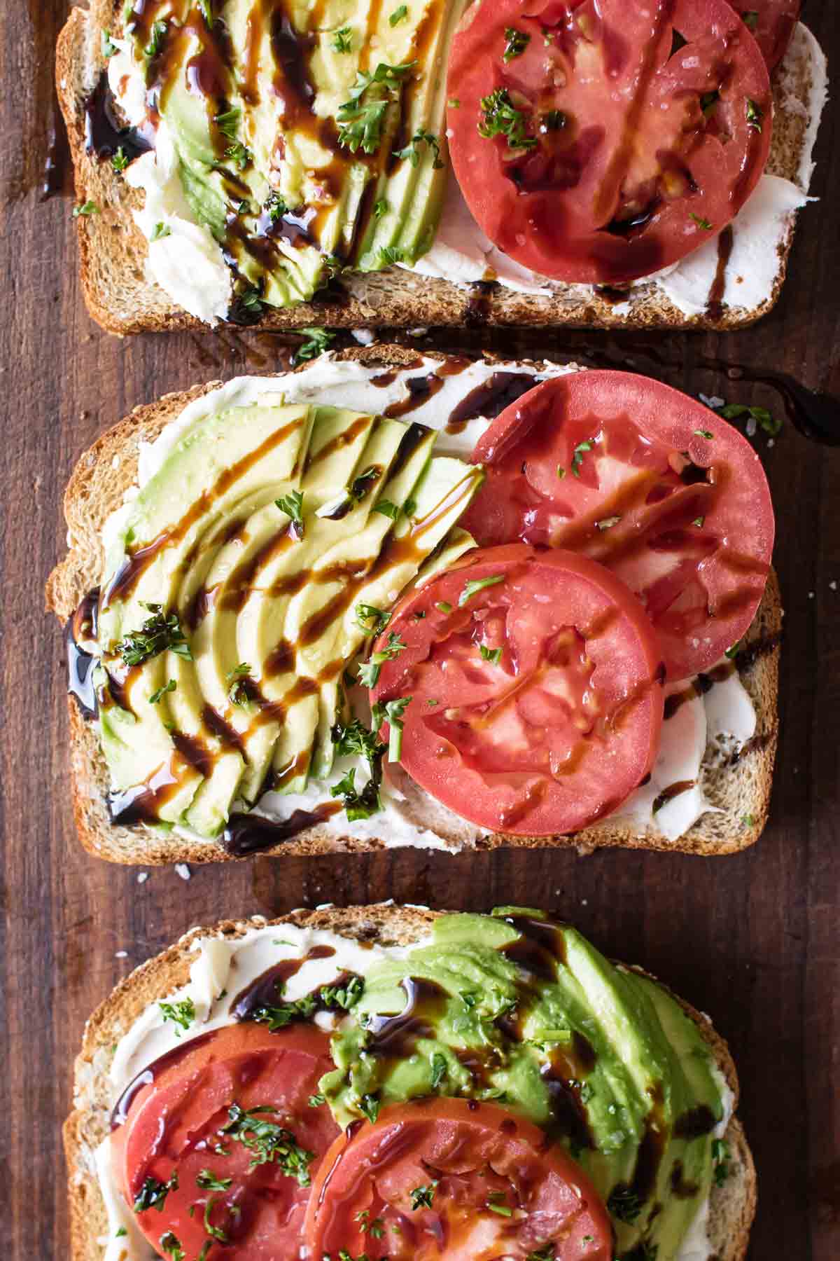 overhead photo of avocado toast with tomatoes and balsamic glaze