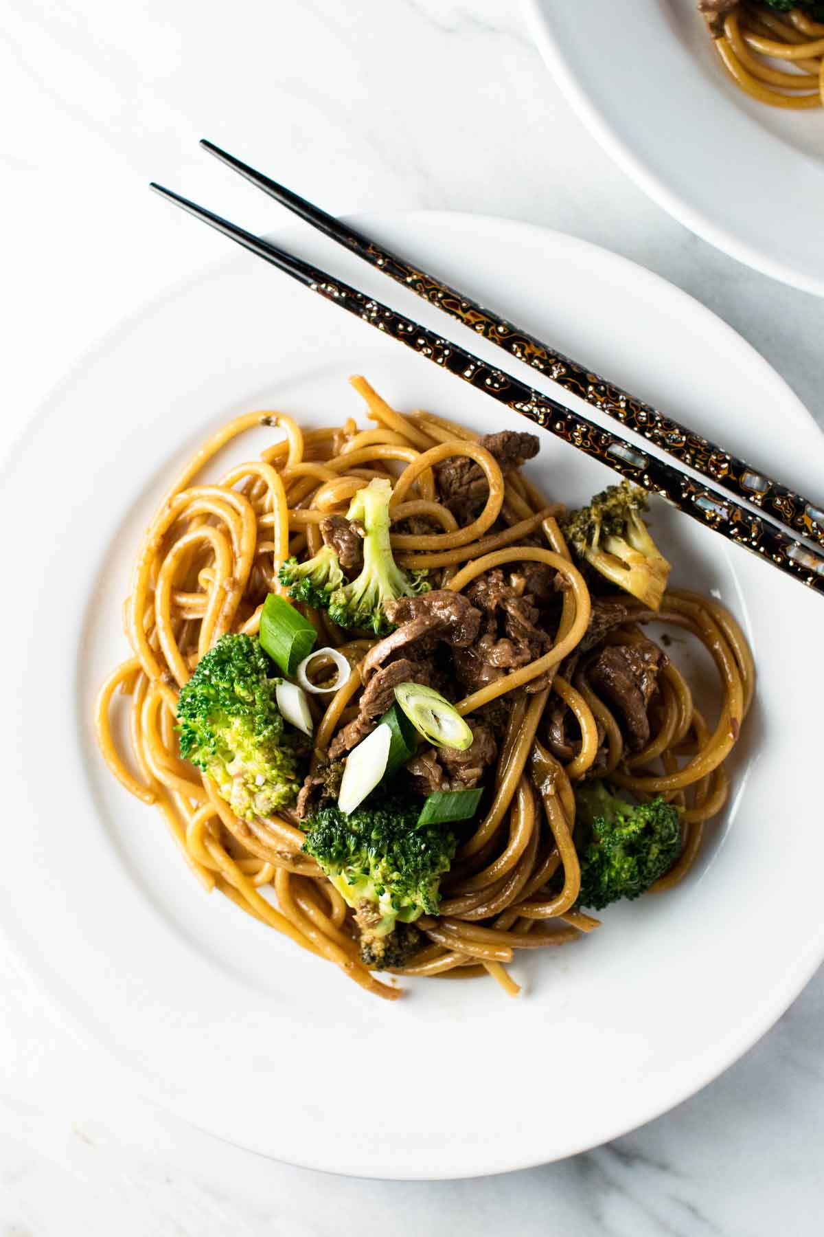 overhead photo of the finished dish on a plate with chopsticks