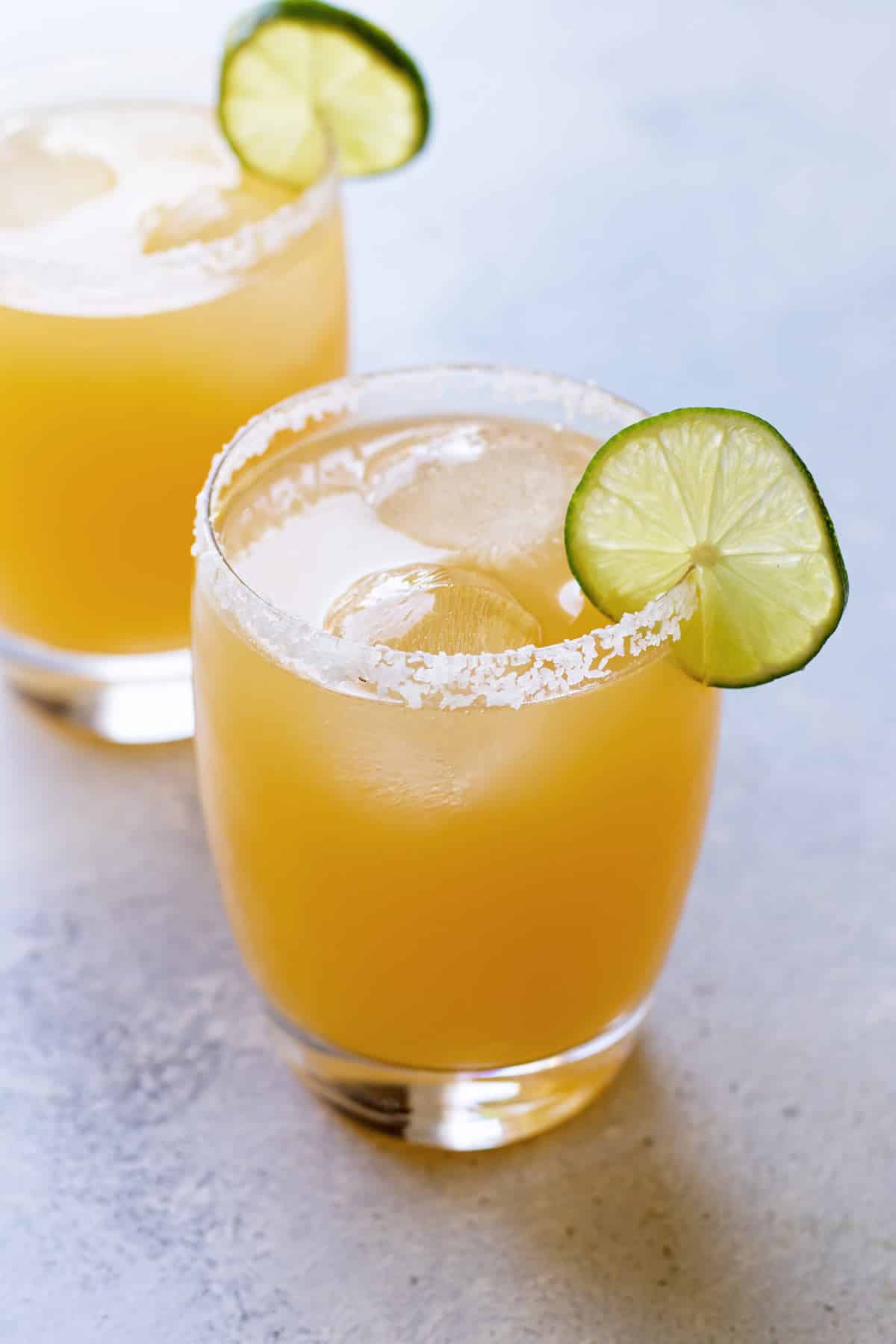 close-up photo of a margarita with a lime garnish