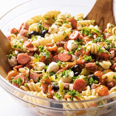 pasta salad in a clear glass serving bowl