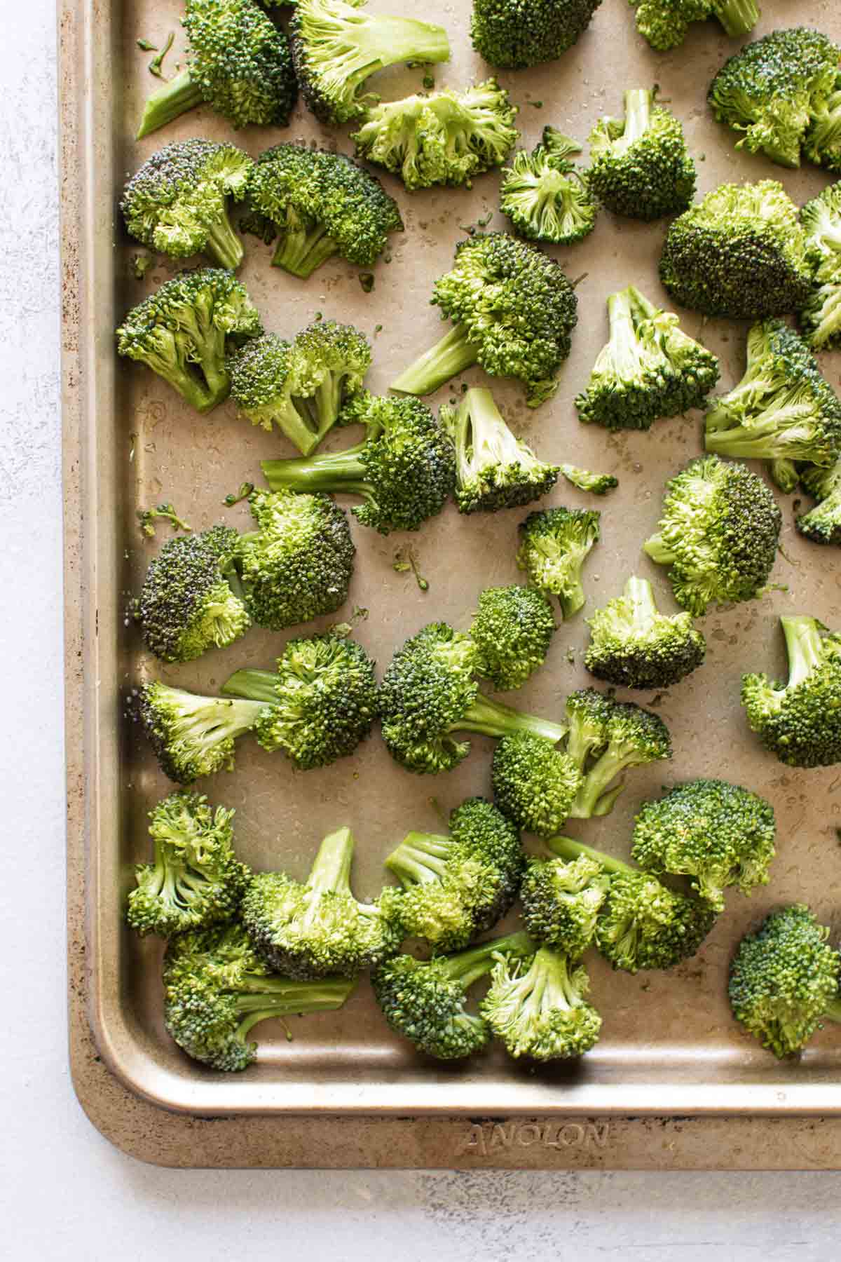 overhead photo of the broccoli on a baking sheet ready to go in the oven