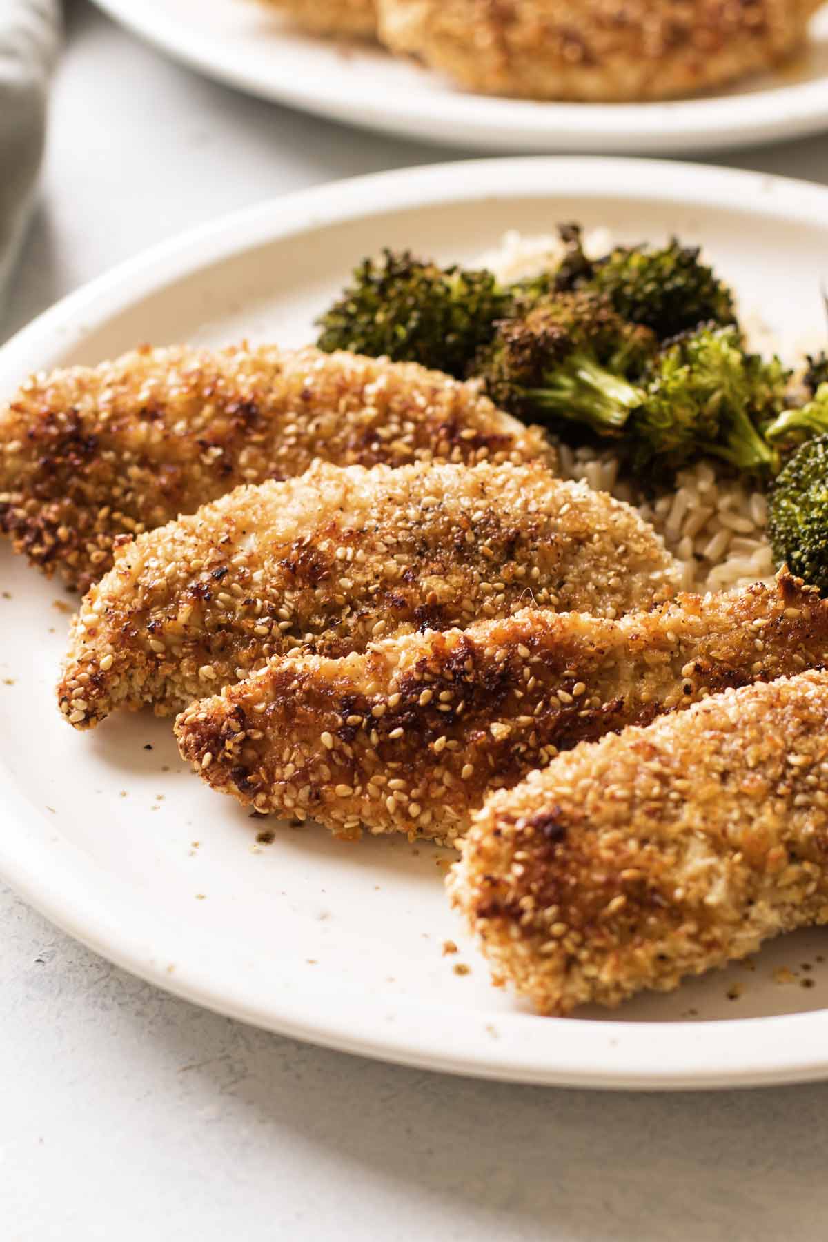 close-up photo of sesame crusted chicken tenders on a plate
