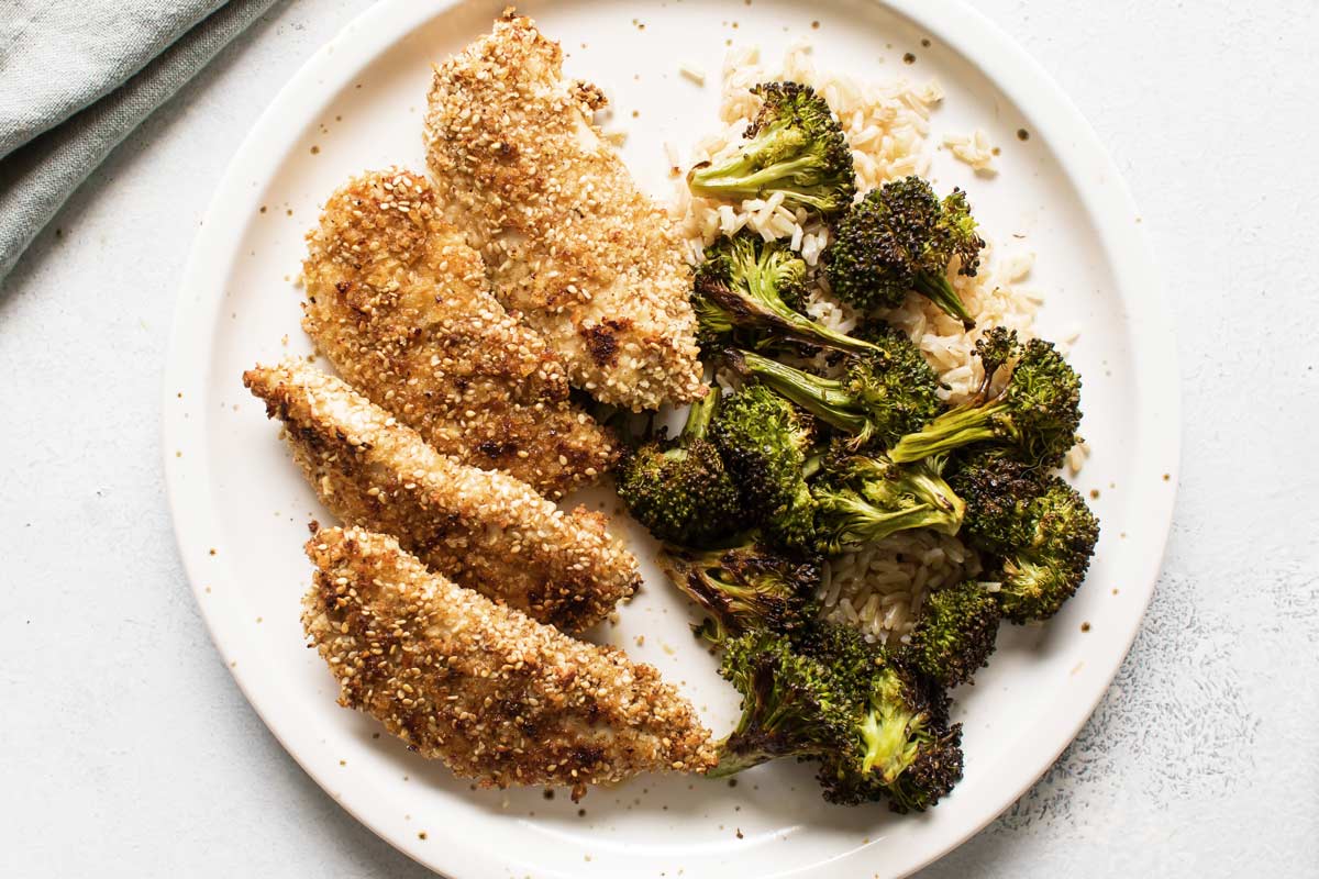 overhead photo of sesame crusted chicken with broccoli and rice