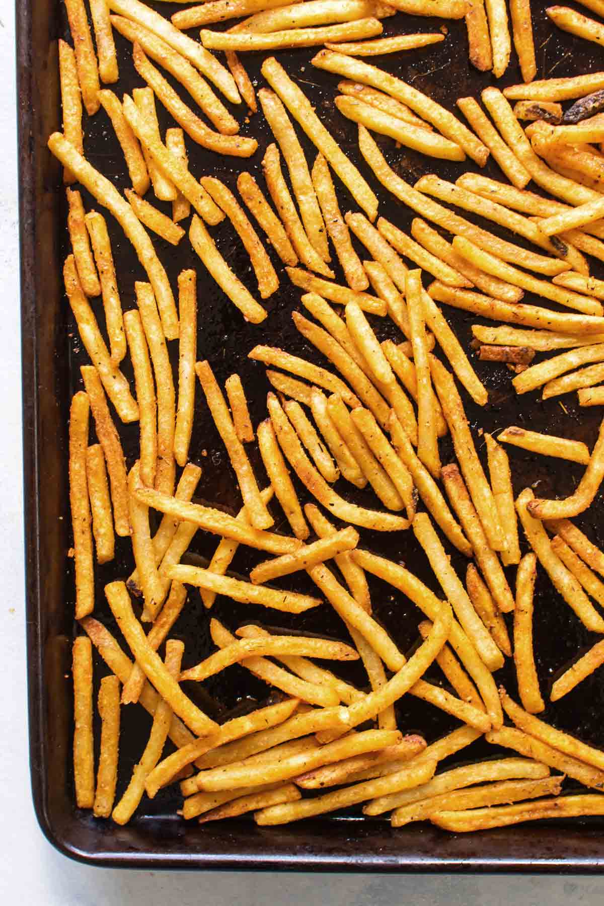 overhead photo of the baked fries on a baking sheet