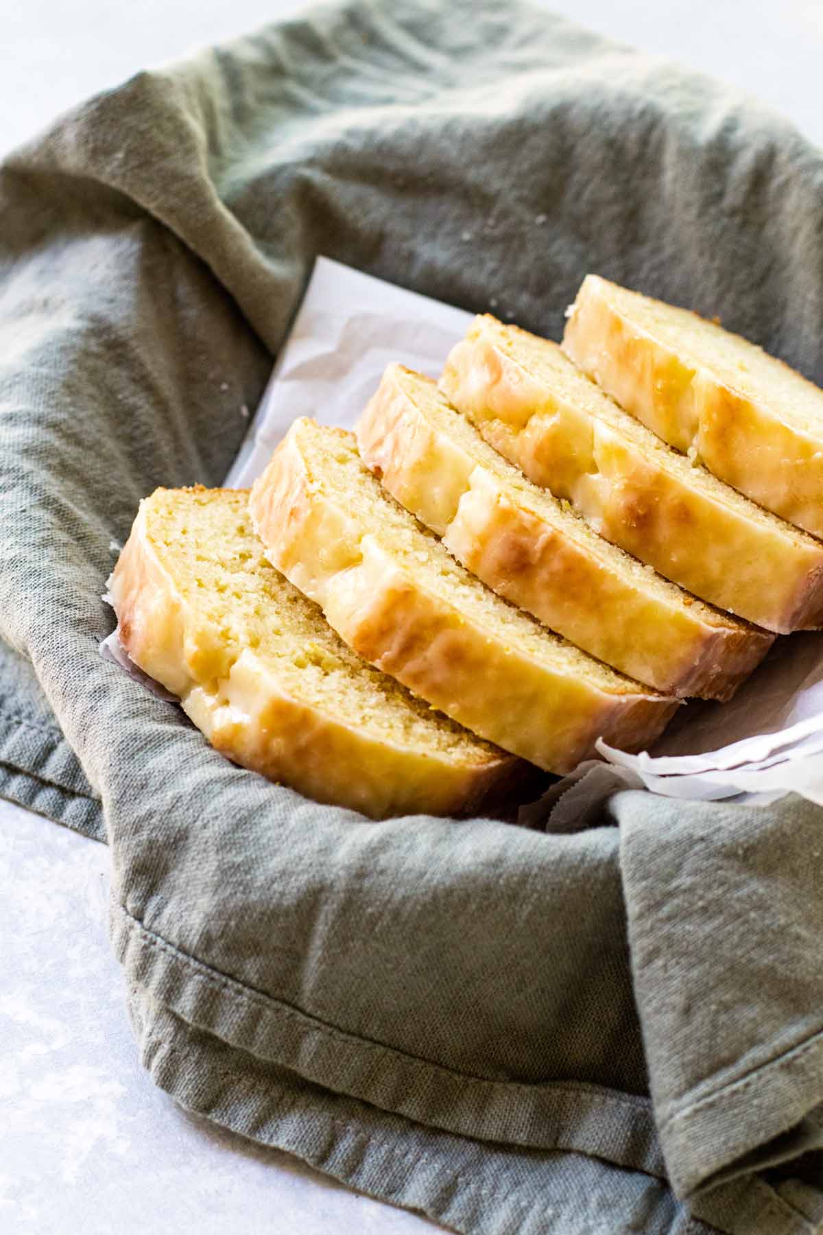 photo of slices of lemon bread in a dish lined with a tea towel