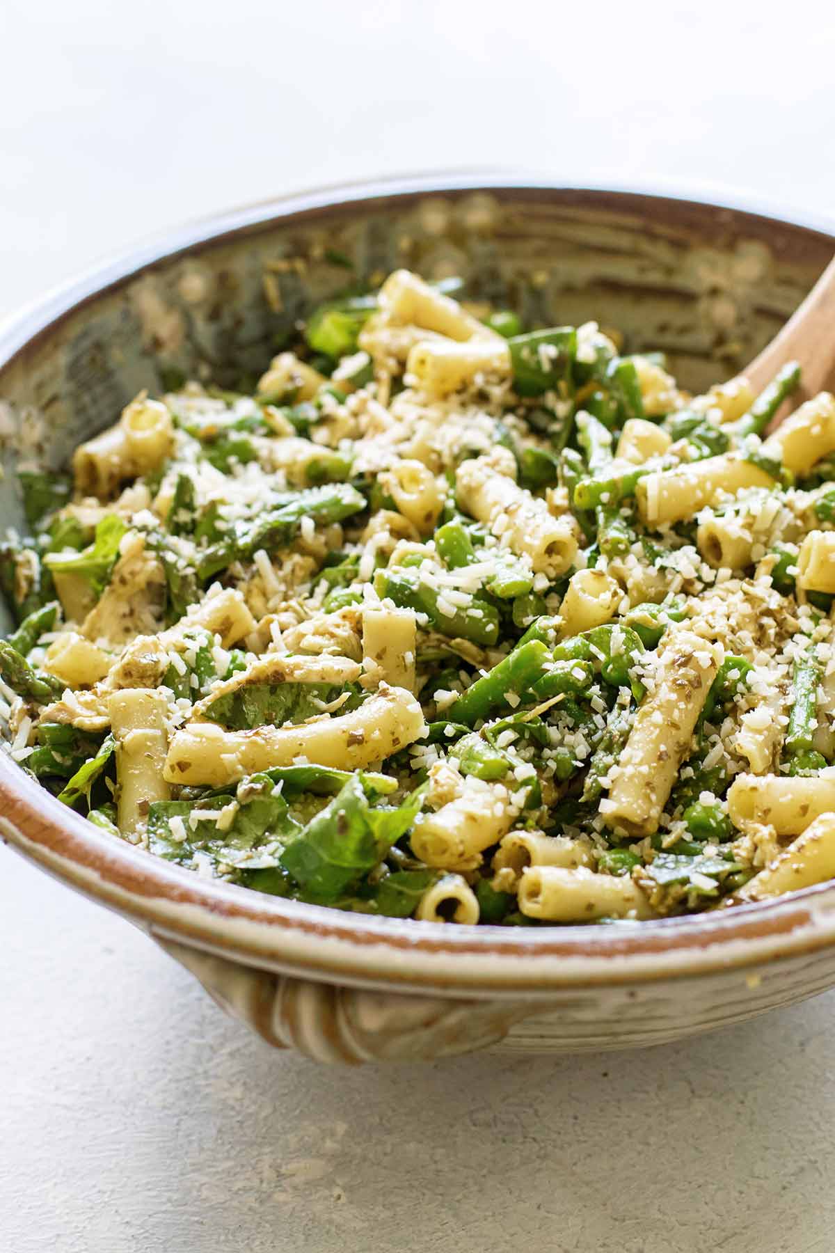 close-up photo of pesto pasta salad in a serving bowl