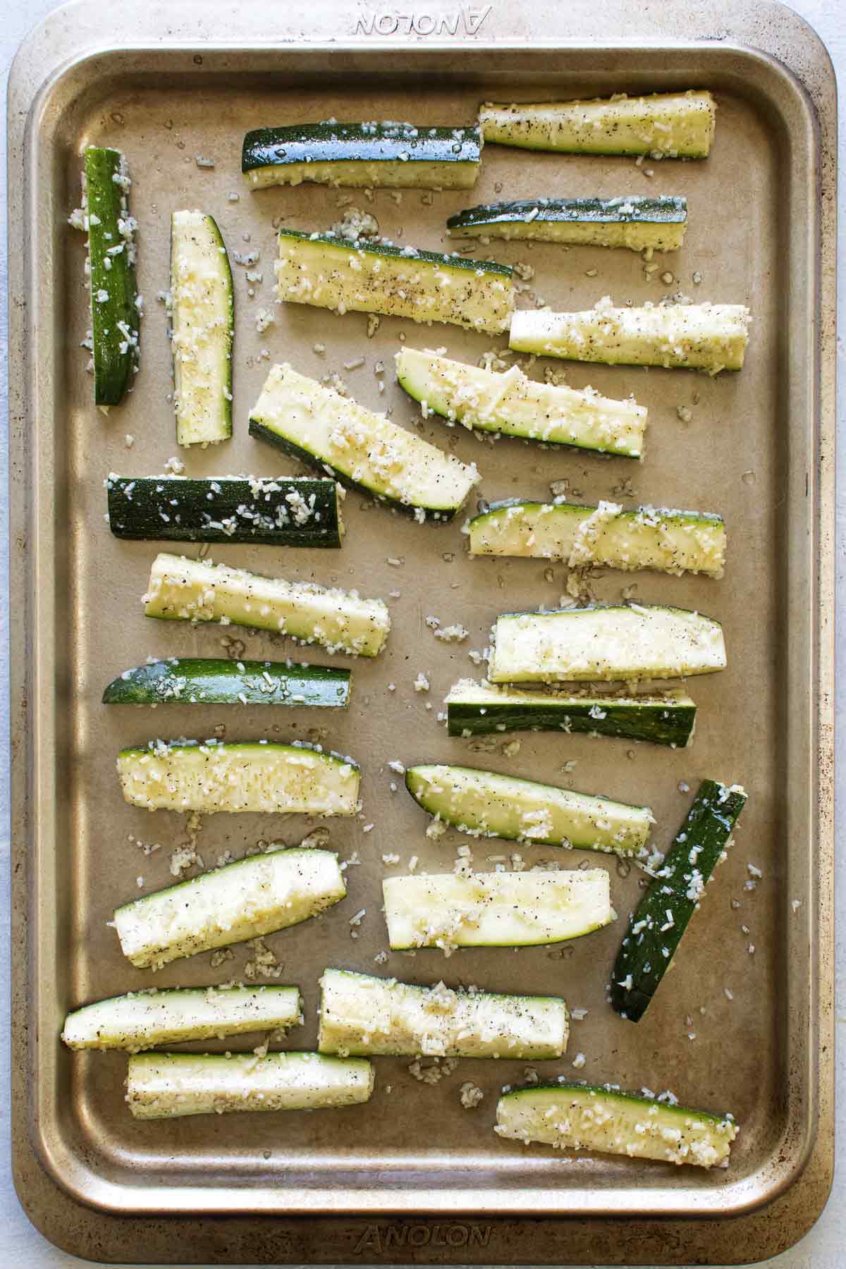 overhead photo of the prepped zucchini on a baking sheet