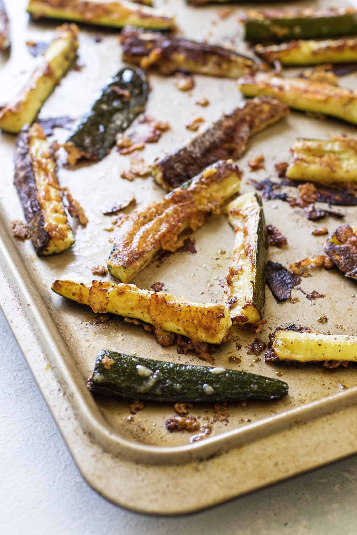 close-up photo of roasted zucchini on a sheet pan