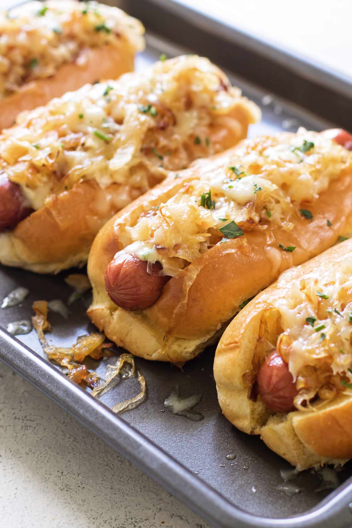 close-up photo of a a hot dog topped with cheese and onions