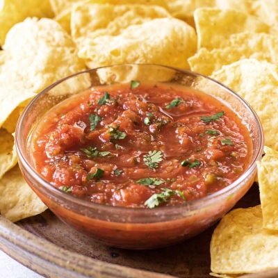 a bowl of salsa with chips