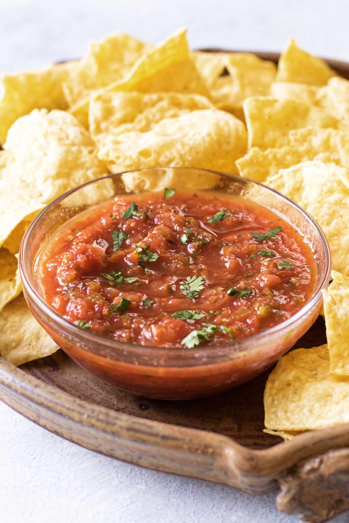  a bowl of salsa with chips.