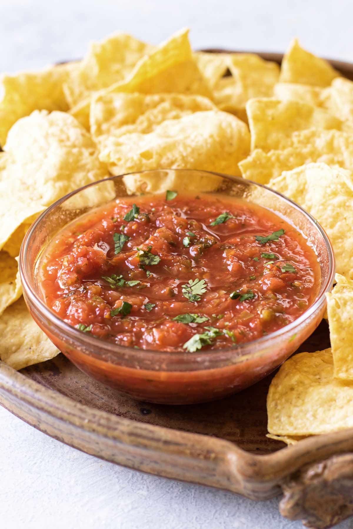 a bowl of salsa with chips