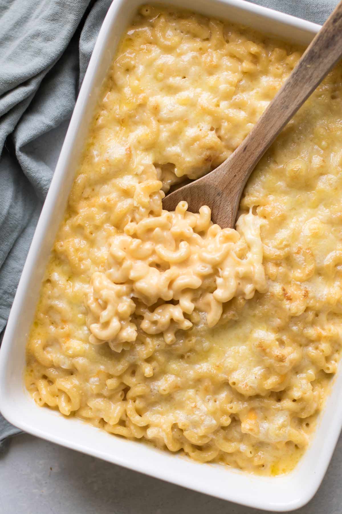 macaroni and cheese in a baking dish with a spoon.