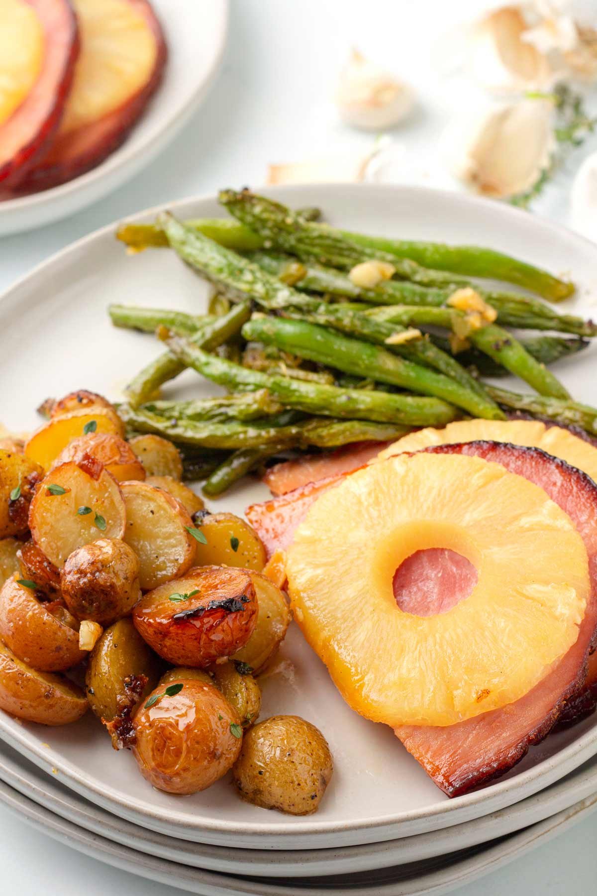 potatoes, green beans, and pineapple ham on plate.
