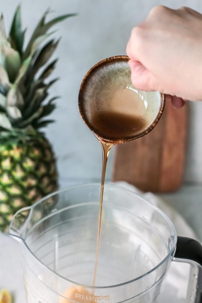 honey being added to the blender.