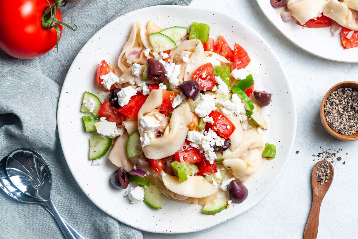 a plate of greek pasta salad.