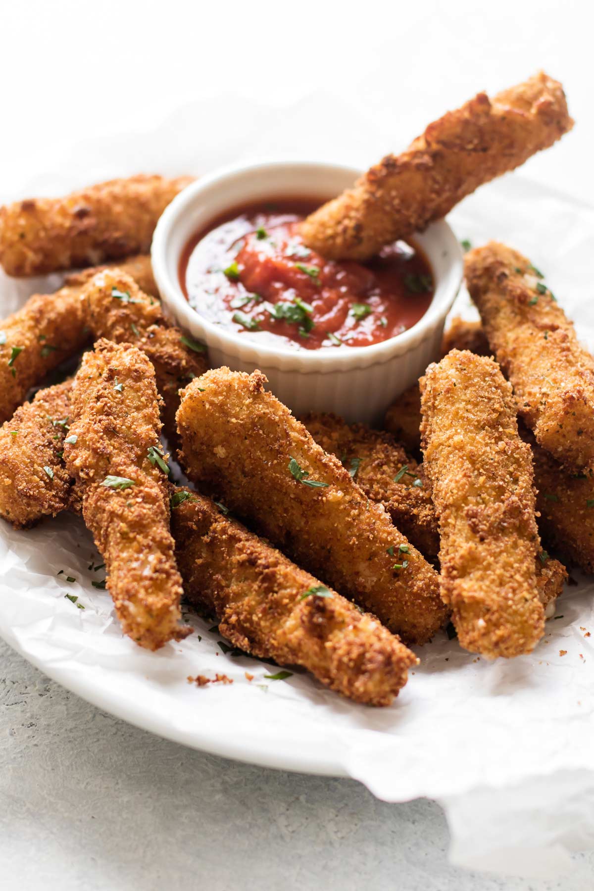a plate of cheese sticks with dipping sauce.