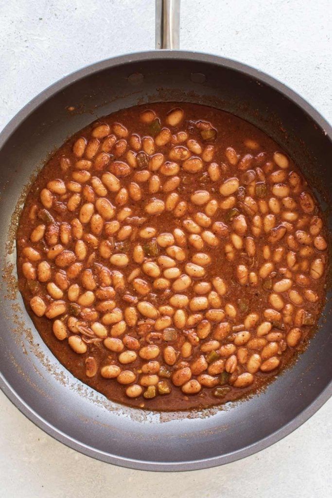 beans and picante sauce simmering in a skillet.