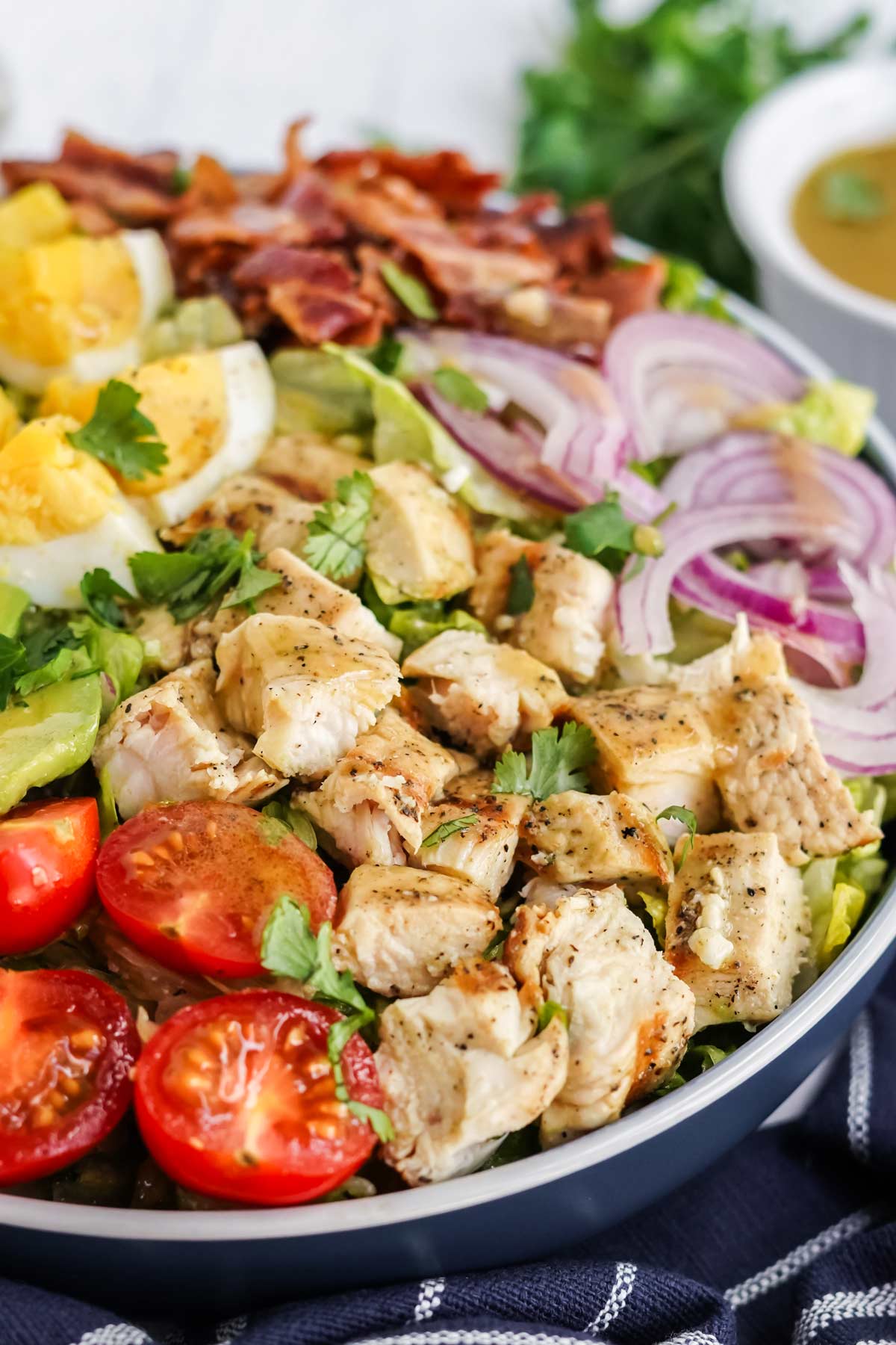 chicken cobb salad in a blue bowl.