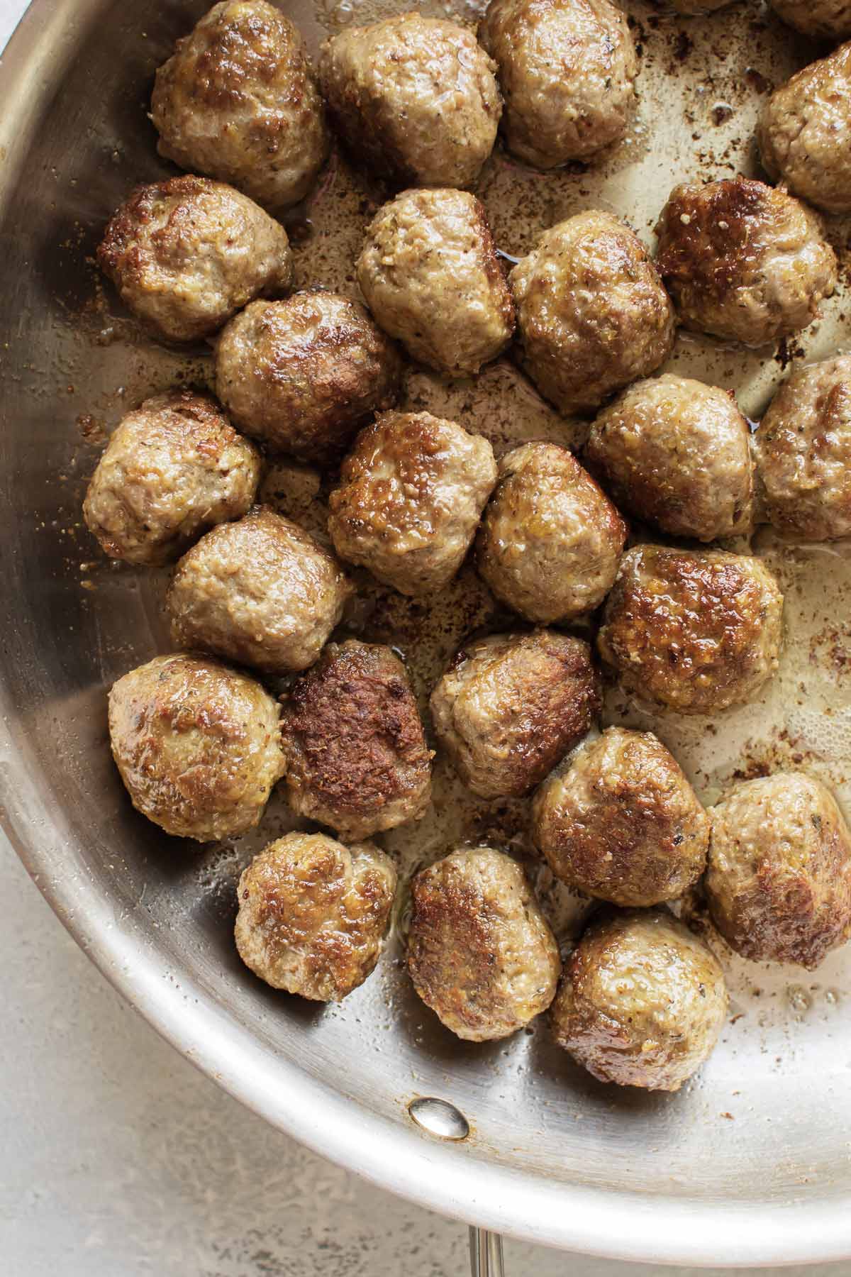 cooked meatballs in a skillet.