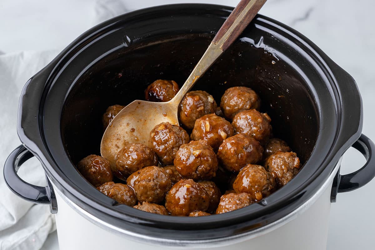 the cooked meatballs in the slow cooker.